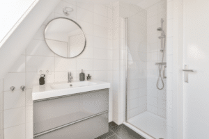 Bright white bathroom with glass walk-in shower inspired by finished basement bathroom ideas